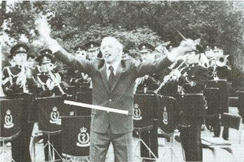 Jimmy Savile conducts the
band